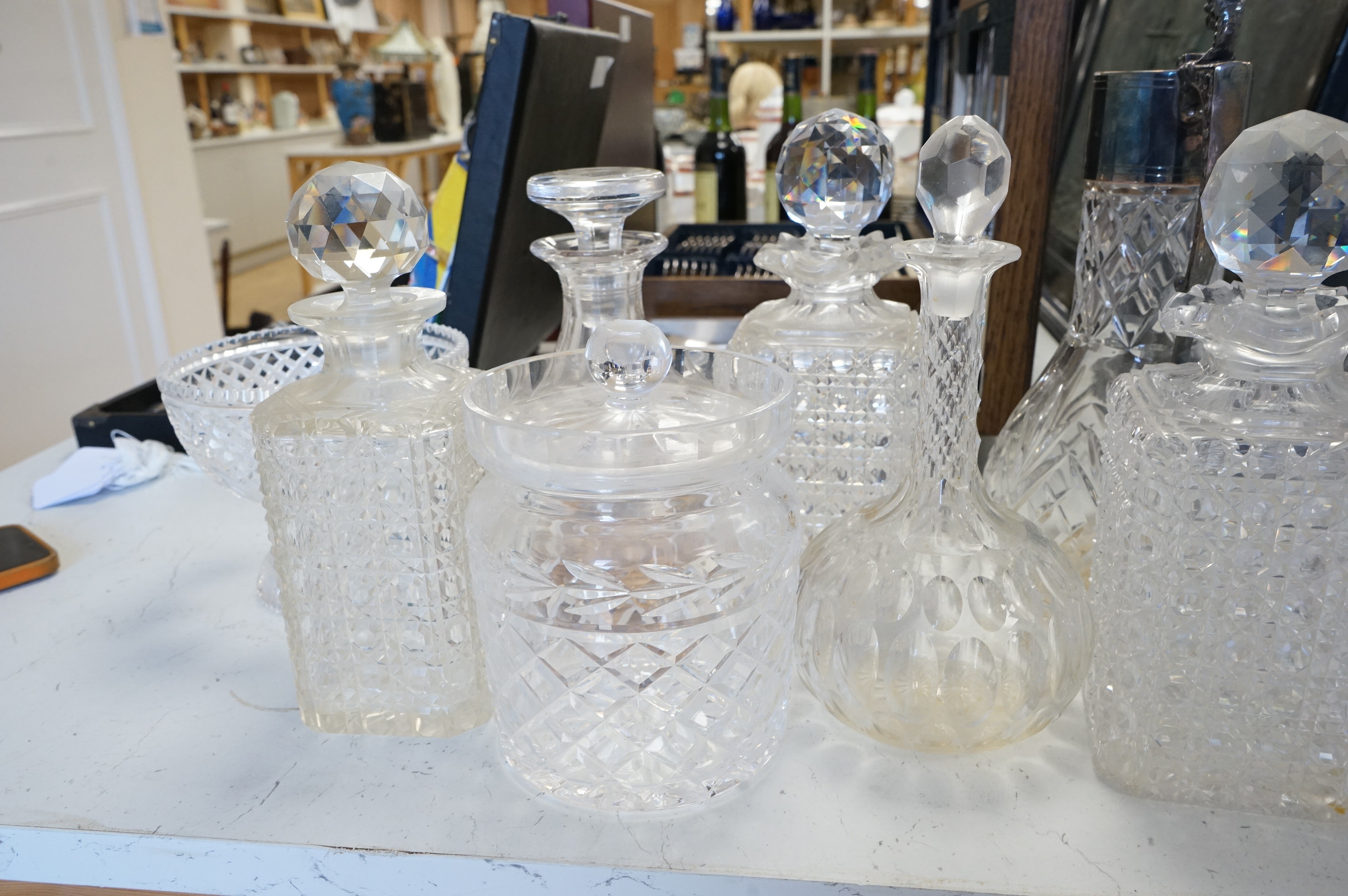 A collection of various cut glass to include decanters and a small pedestal bowl, largest 30cm high